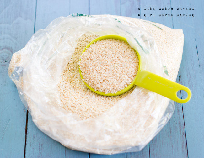 small bag of sesame seeds with measuring spoon cup inside 