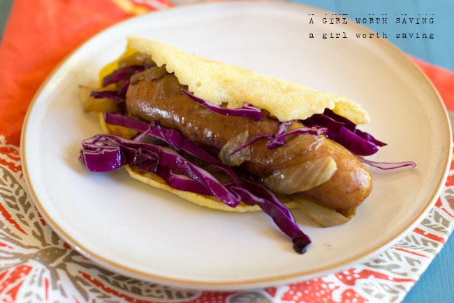 paleo tortilla wraps with some cooked cabbage, onions and a sausage inside