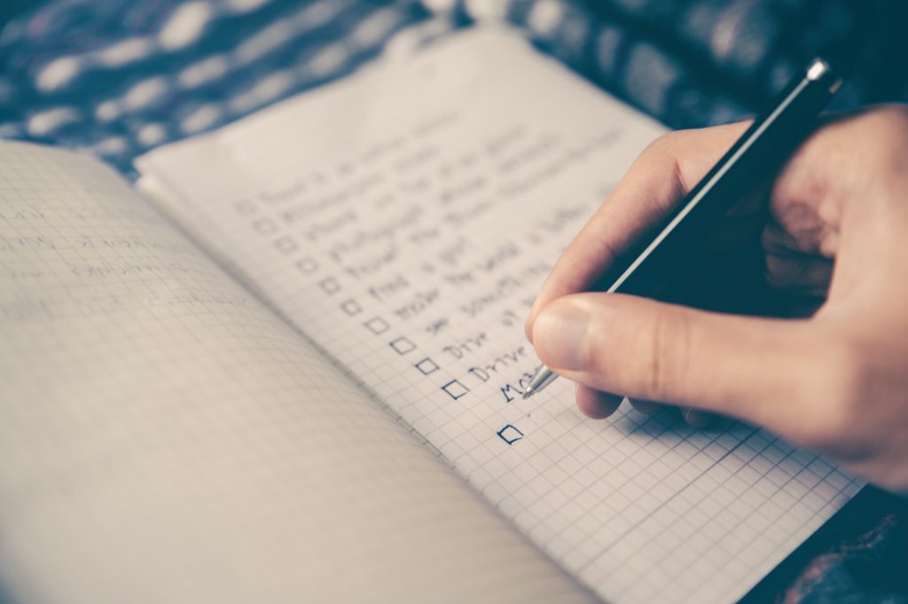 Self-Care Tips & Techniques For Dealing With Depression Kelly Bejelly a person writing out a depression self care checklist