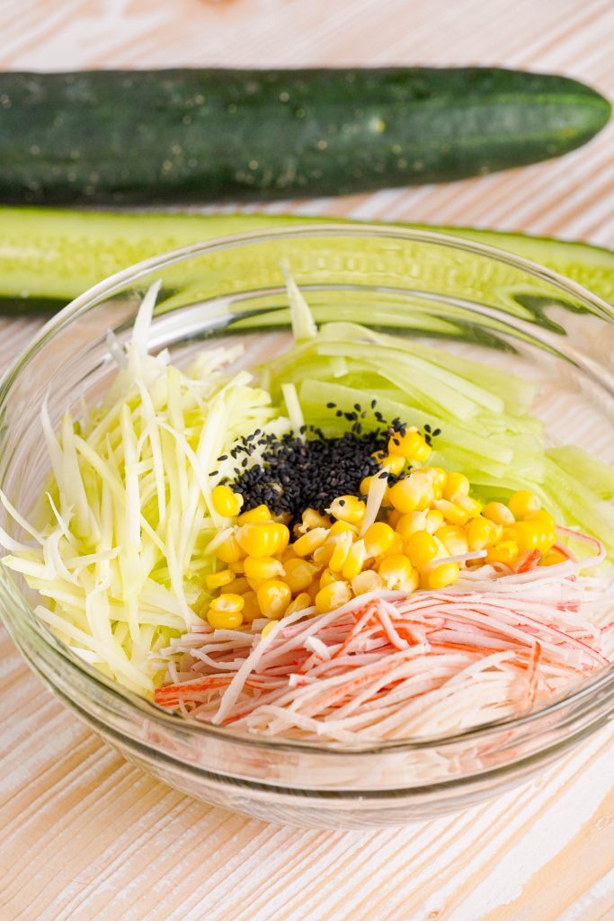 Kani Salad Kelly Bejelly Sliced crab, cucumber, mango and black sesame seeds in a bowl