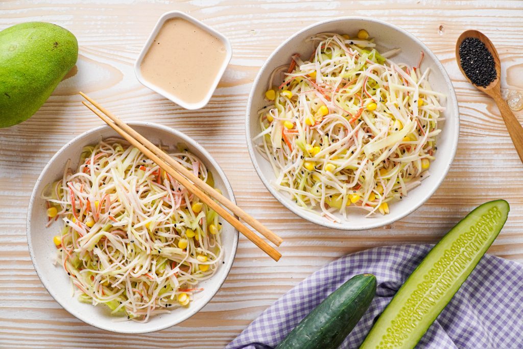 Kani Salad Kelly Bejelly Two bowls of dry kani salad in bowls with spicy mayo sauce on the side