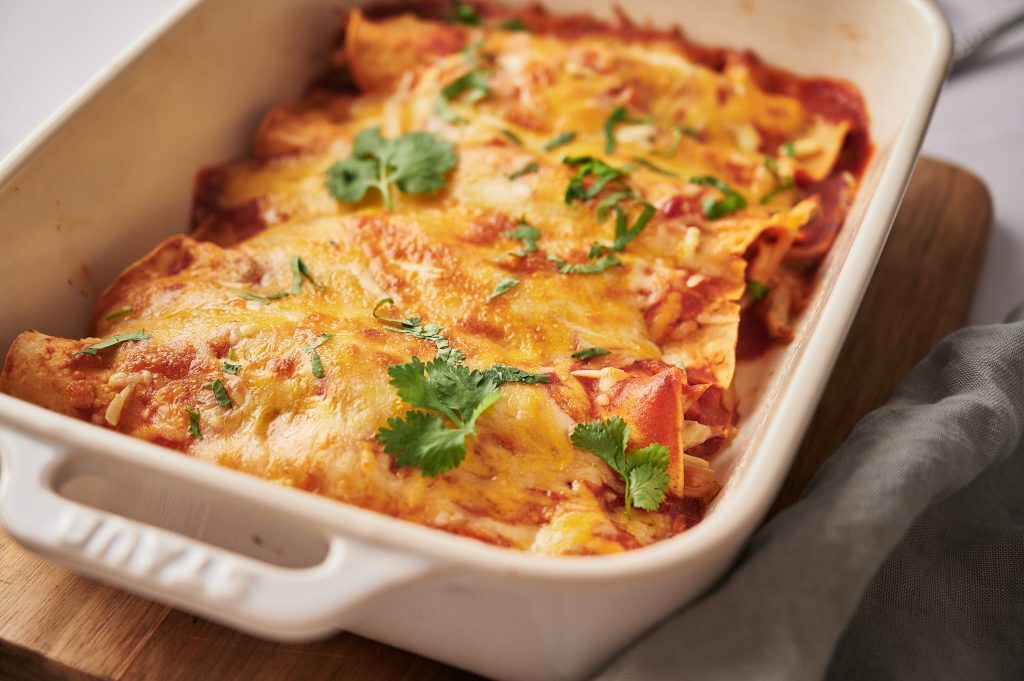 Gluten Free Enchiladas That Will Blow Your Taste Buds Away Kelly Bejelly Close up of gluten free enchiladas in a casserole dish