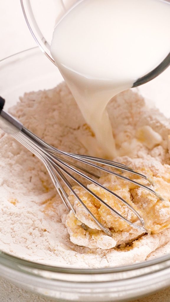 Mixing wet ingredients into a bowl for corn nuggets recipe