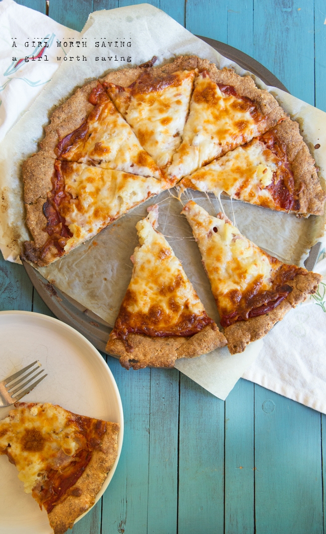 sliced keto pizza crust with two slices set to the side 