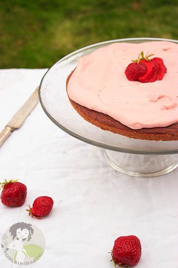 Strawberry Coconut Flour cake on a cake stand outdoors