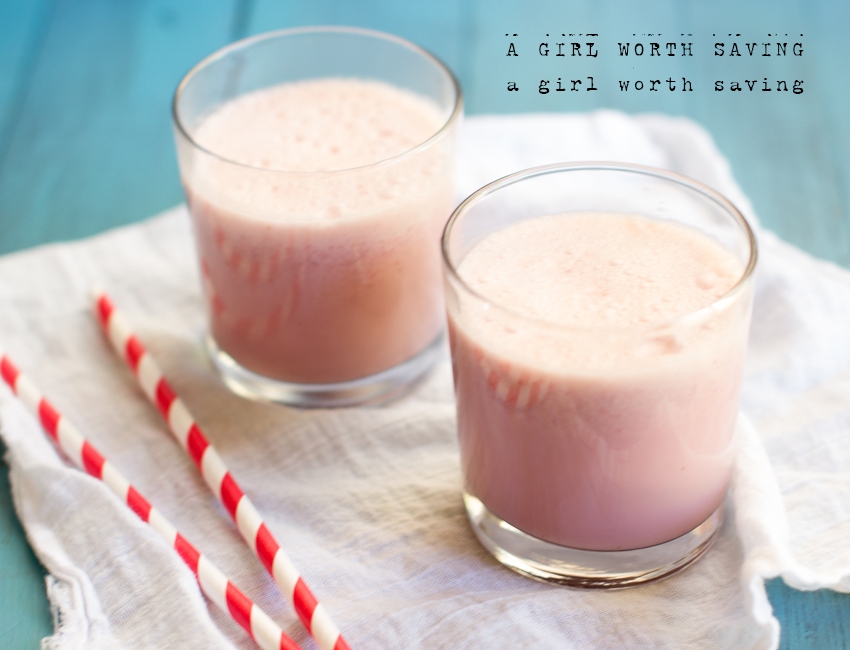 Strawberry Milk in two glasses with straws on the side