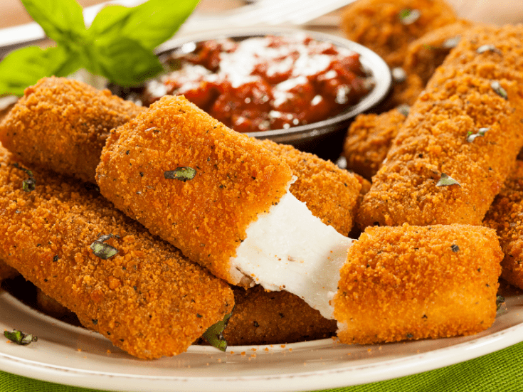 homemade gluten free mozzarella sticks with cheese oozing out