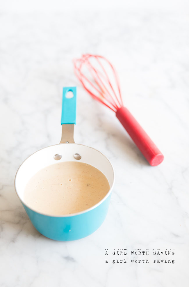 dairy free eggnog in a small pan with a whisk near it. 