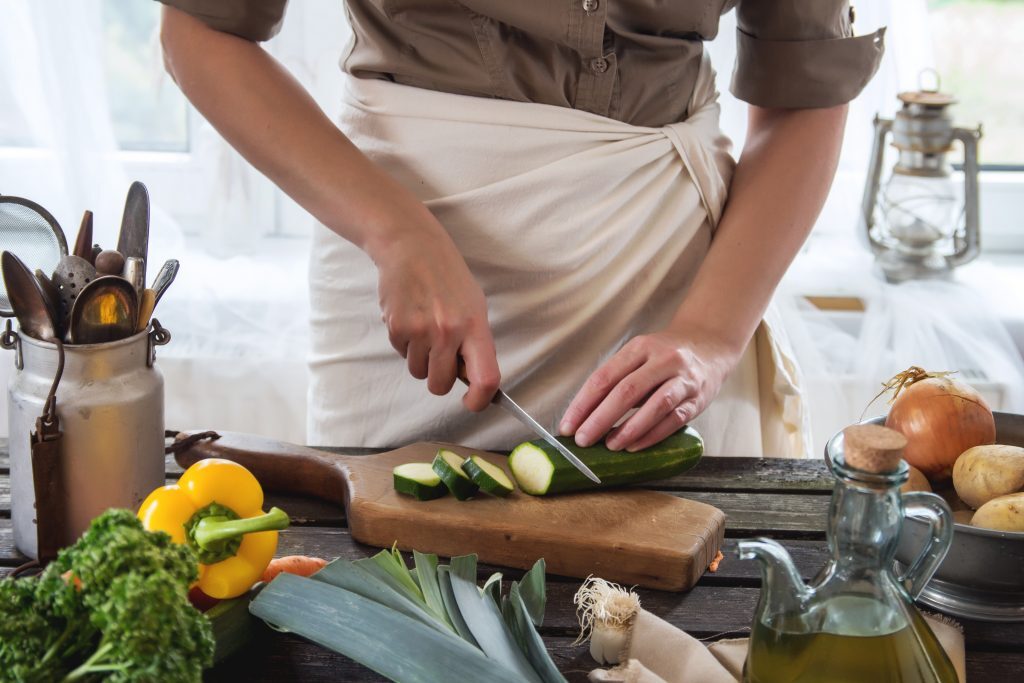 7 Ways to Make Your Kitchen a Health Haven Kelly Bejelly woman cutting zucchini in a kitchen