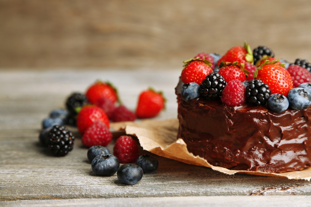 Paleo Chocolate Cake Kelly Bejelly Tasty paleo chocolate cake with different berries on wooden table