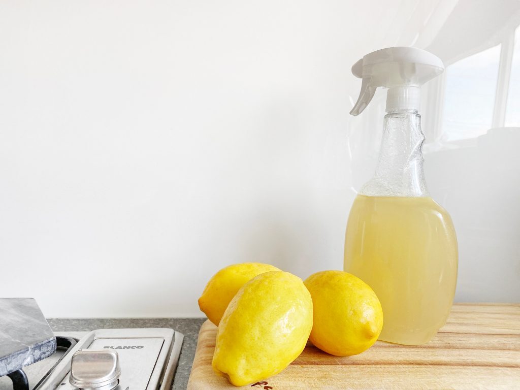 Spring Cleaning for Mental Health and Wellness Kelly Bejelly Natural cleaner made with lemons near a cook top