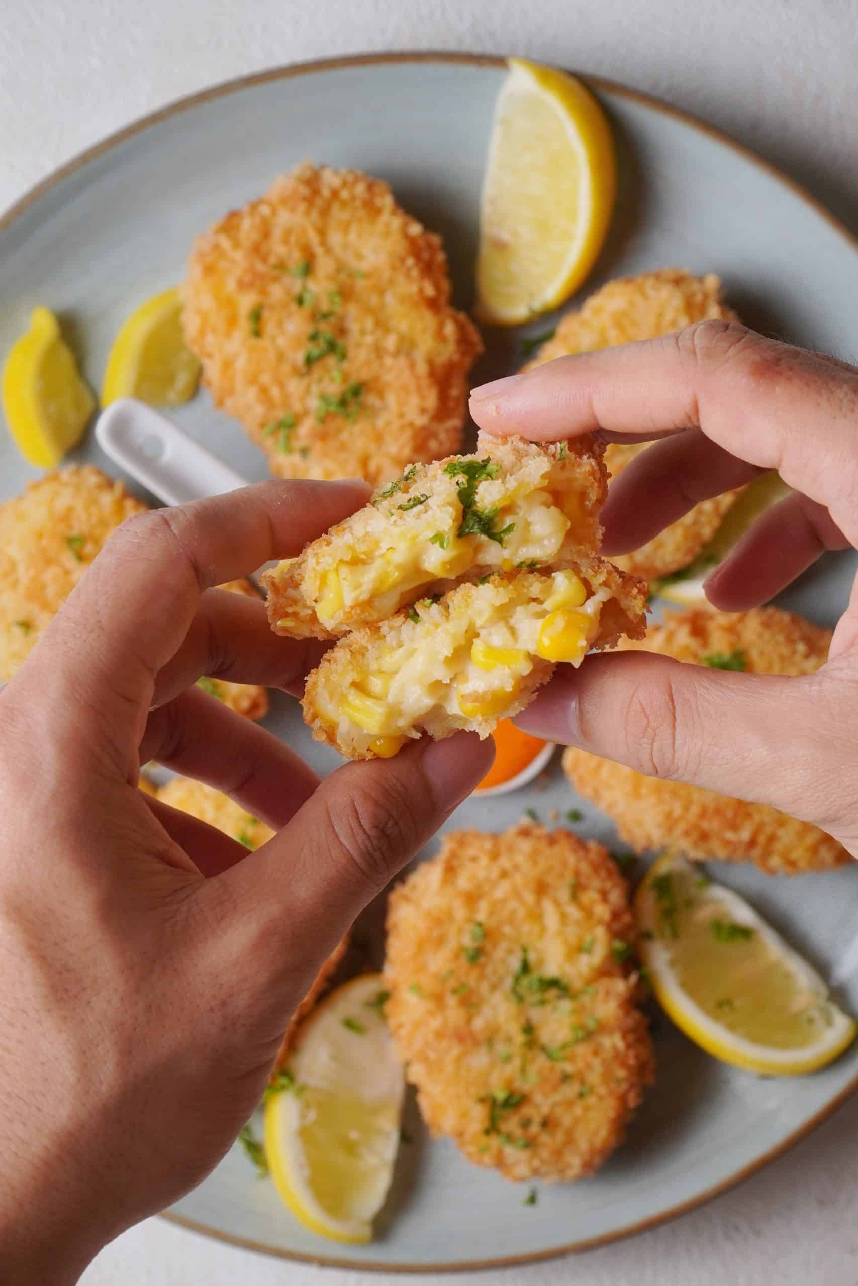 Recipe Index Kelly Bejelly woman holding deep fried corn nuggets in her hand