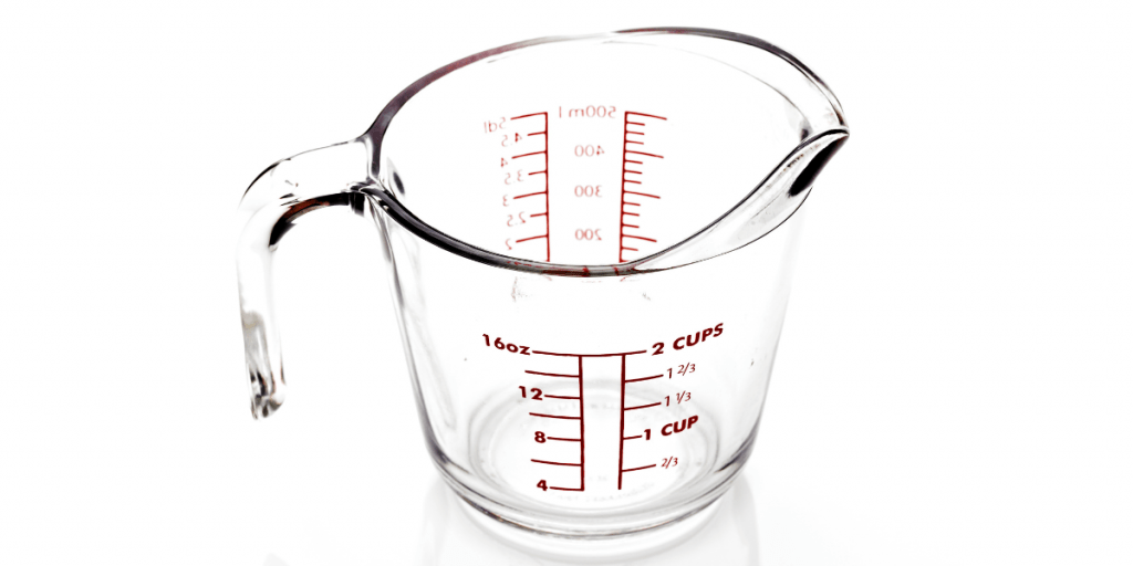 How Many Ounces in a Cup? Kelly Bejelly how many ounces in a cup text overlay with a measuring cup in the background