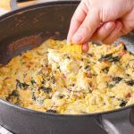 The Best Keto Spinach Artichoke Dip You'll Ever Eat Kelly Bejelly cast iron with spinach artichoke dip