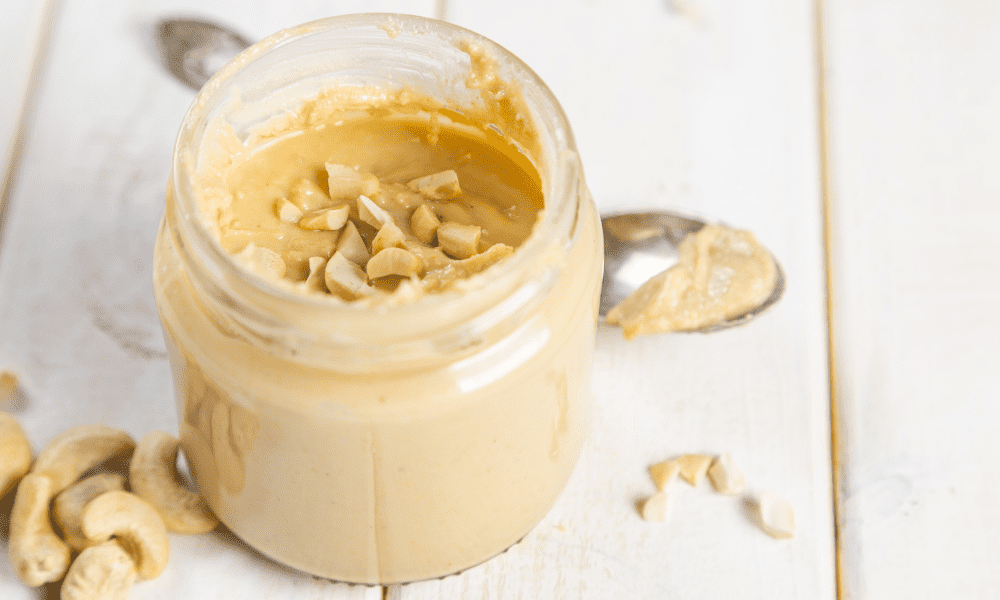 10 Substitutes for cashew butter Kelly Bejelly jar of cashew butter with cashews on the counter