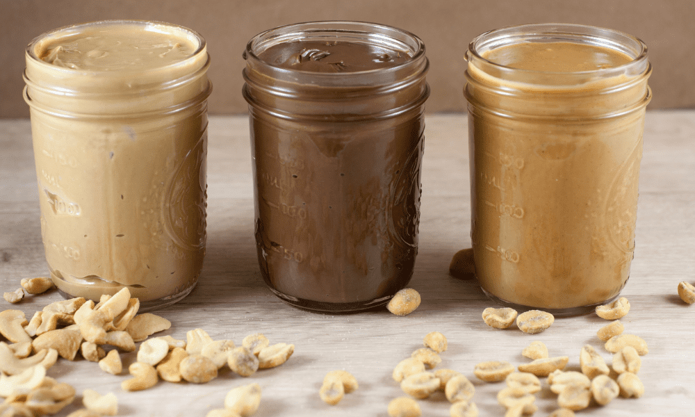 10 Substitutes for cashew butter Kelly Bejelly cashew butter substitutes in jars with loose nuts on the table