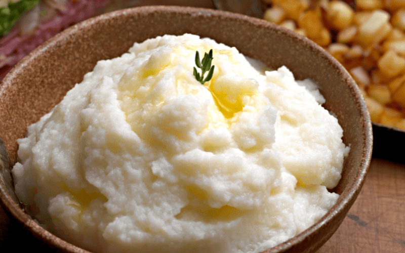 How to Thicken Mashed Potatoes: 4 Quick & Easy Solutions Kelly Bejelly close up of mashed potatoes in a bowl with melted button on top