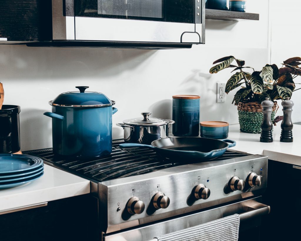 The Best Non-Toxic Cookware Kelly Bejelly Different cast iron pans on a stove in this best non toxic cookware review