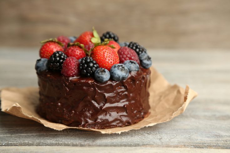 Paleo Chocolate Cake Kelly Bejelly Tasty paleo chocolate cake with different berries on wooden table
